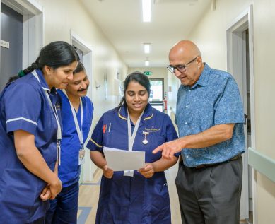 Hospital staff discuss a file
