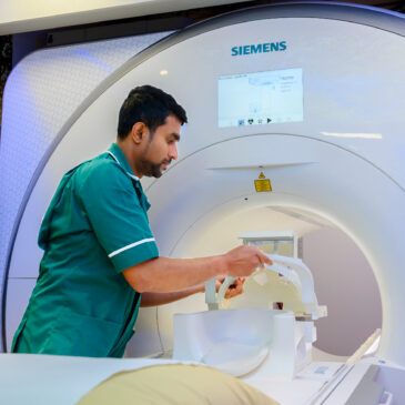 A technician operating the MRI machine