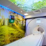 The MRI room with calming natural scenes on the walls and ceiling