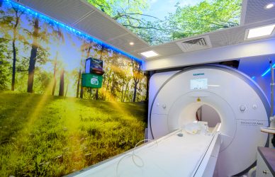 The MRI room with calming natural scenes on the walls and ceiling