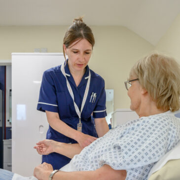 A nurse takes a patient's blood pressure