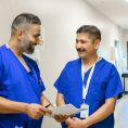 Nurses talk over a file
