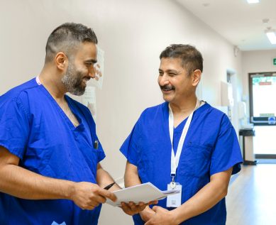 Nurses talk over a file