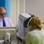 Ophthalmologist using equipment to test a patient's sight
