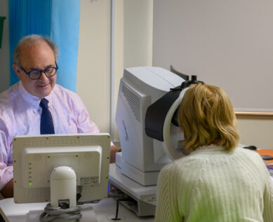 Ophthalmologist using equipment to test a patient's sight