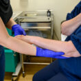 A nurse examines a petient's arm