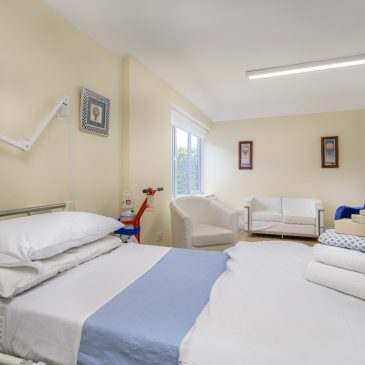 A private hospital room with fresh towels and gown