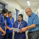 Staff in discussion over a file