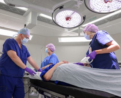 Surgeons and an anaesthetist with a patient in theatre