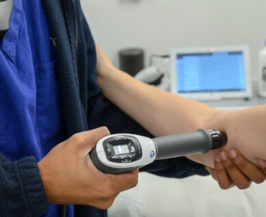 A TENS machine being used on a patient's elbow