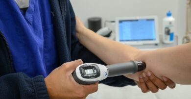 A TENS machine being used on a patient's elbow