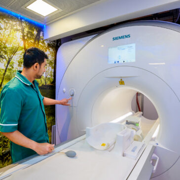 An MRI technician operates the MRI machine