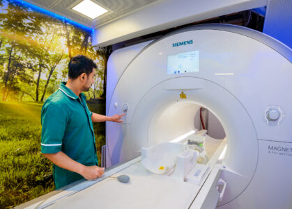 An MRI technician operates the MRI machine