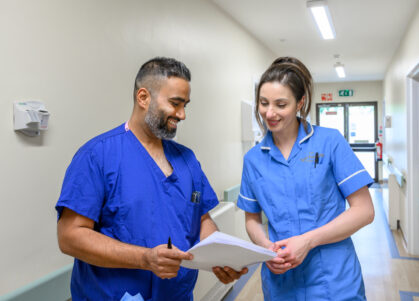 Nurses in discussion over a file