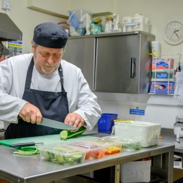 A chef prepares fresh food in the kitchen