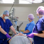 Surgeons treating a patient in theatre