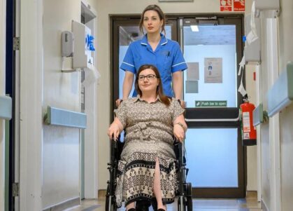 Nurse assisting patient in wheelchair